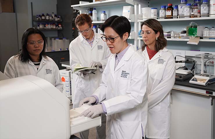 Four scientists working in the Cai Lab