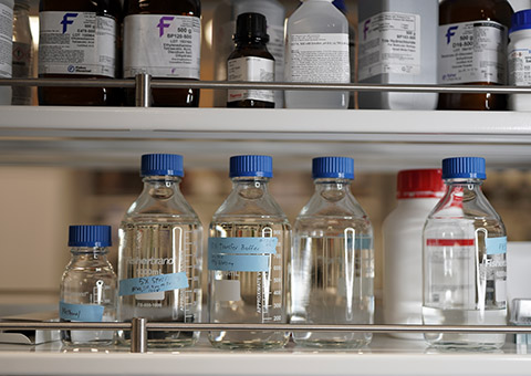 Glass bottles on shelf in lab