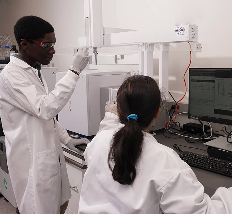 Two IBRI researchers working with the Bruker HD Fourier 80 MHz NMR spectrometer
